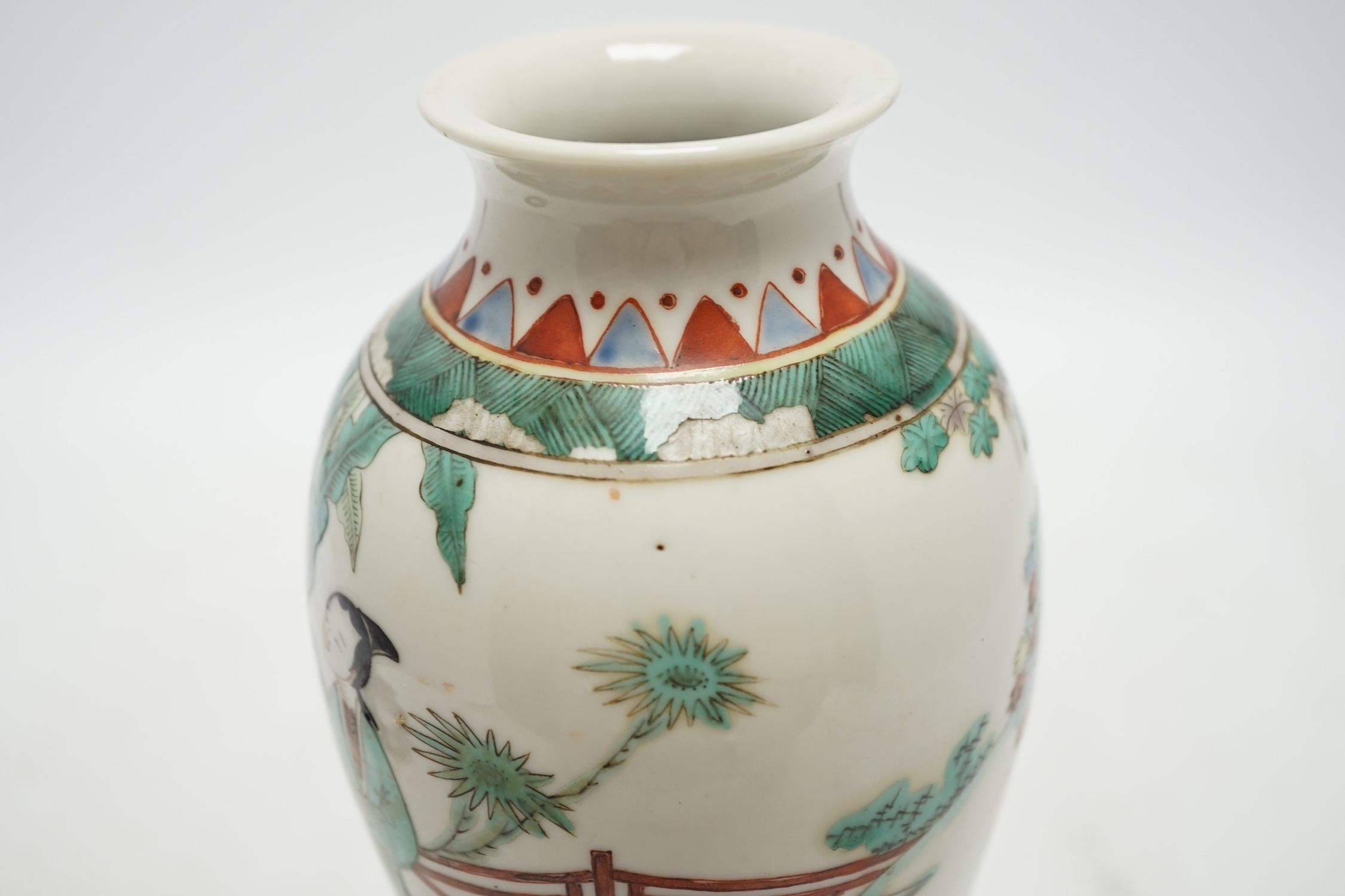 A 19th century Chinese porcelain famille verte vase and associated hardwood stand, 23cm high. Condition - good